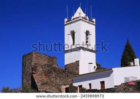 The Clock Tower and stone battlements. The historic, fortified town of Monsaraz, built within medieval defensive walls. Evora, Alentejo Region, Portugal. Royalty-Free Stock Photo #2459898973