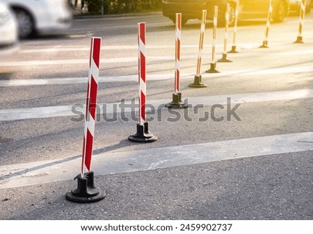Road poles with red stripes for pakring and drive control. Outdoors