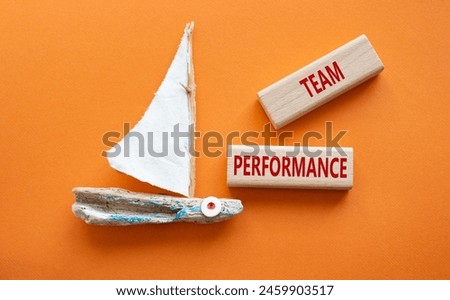Team Performance symbol. Wooden blocks with words Team Performance. Beautiful orange background with boat. Business and Team Performance concept. Copy space.
