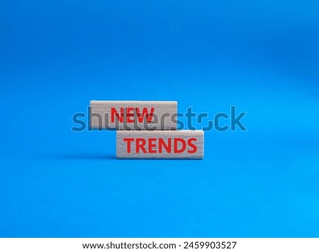 New Trends symbol. Wooden blocks with words New Trends. Beautiful blue background. Business and New Trends concept. Copy space.