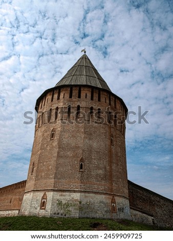 A tower with loopholes of an ancient fortress Royalty-Free Stock Photo #2459909725