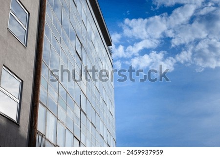 Close up on a vintage business building in front a blue sky in a sunny afternoon in a business district, with office space available.