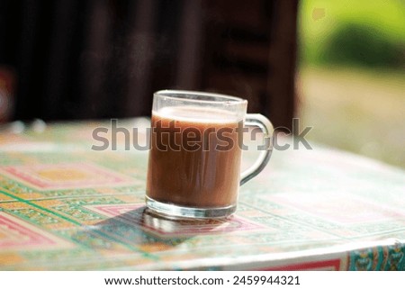
a glass of hot chocolate is ready to be enjoyed