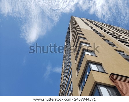 high-rise building against the blue sky. Low angle shooting