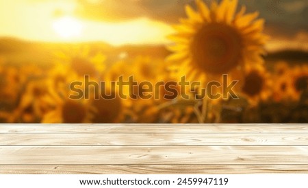 Empty wood table top with blur background of sunflowers field. The table giving copy space for placing advertising sunflower product on the table along with beautiful sunflower background.