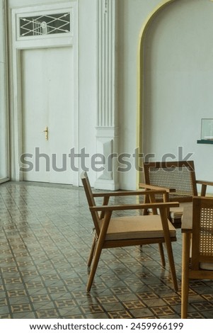 Vintage square tile yellow brown and light brown detail texture background pattern with wooden chairs and table interior design