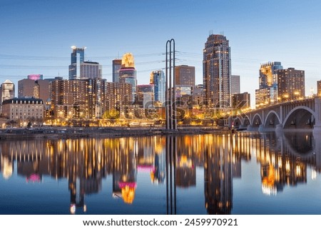 Minneapolis, Minnesota, USA downtown city skyline on the Mississippi at dusk.