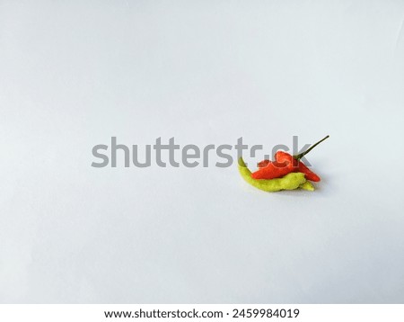 Colored variants of chili peppers stacked on a white background


