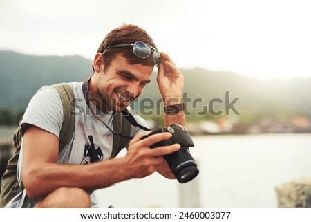 Man, camera and travel photographer at ocean as photo journalist for tourism, hobby or water. Male person, pictures and outdoor creative at sea in Australia or blog equipment, view or professional