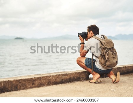 Man, camera and photography by sea as travel journalist for picture memory for creative, digital or lens. Male person, equipment and shoot in Thailand for nature trip as photographer, view or artist