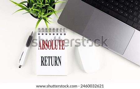 ABSOLUTE RETURN text on notebook with laptop, mouse and pen 