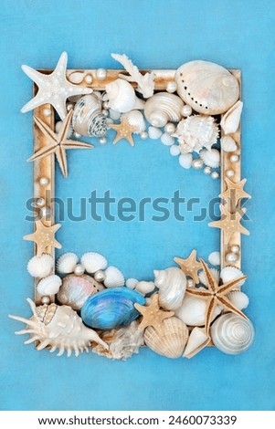 Pearl and sea shell decorative abstract gold picture frame design on mottled blue background. Natural nature  border design with large collection of shells.