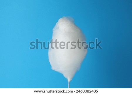One sweet cotton candy on light blue background