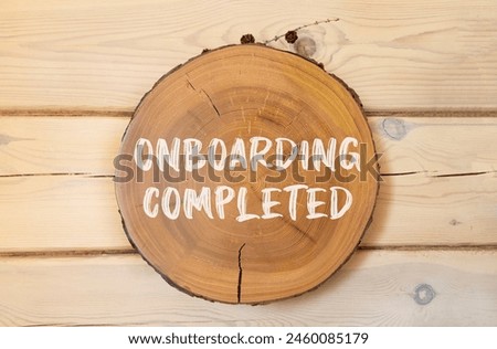 Onboarding completed symbol. Concept words Onboarding completed on beautiful wooden circle. Beautiful wooden wall background. Business onboarding completed concept. Copy space.
