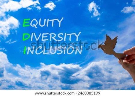 EDI equity diversity inclusion symbol. Concept words EDI equity diversity inclusion on blue sky clouds background. Wooden bird. Business EDI equity diversity inclusion concept. Copy space.