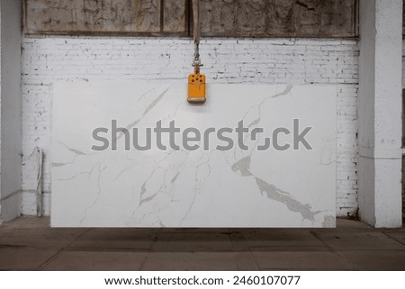 Picture of a marble slab on a hanger, shot in natural light, a cut of decorative marble in a warehouse, a large piece of marble. High Resolution. Quartz Santa Margherita Mistral