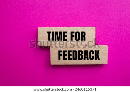 Time for feedback words written on wooden blocks with pink background. Conceptual time for feedback symbol. Copy space.