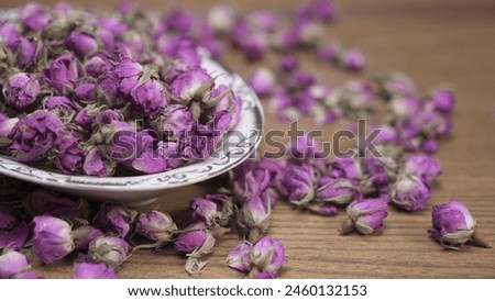 Dried damask rose in white dish