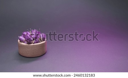 Dried damask rose in small wooden bowl