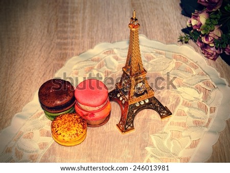 Figurine of The Eiffel Tower and colorful cookies 