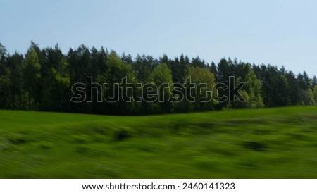 Landscape, green field along the highway, slightly blurred photo. High quality photo