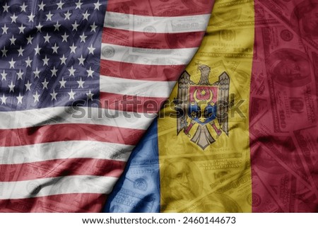 big waving colorful flag of united states of america and national flag of moldova on the dollar money background. finance concept . macro