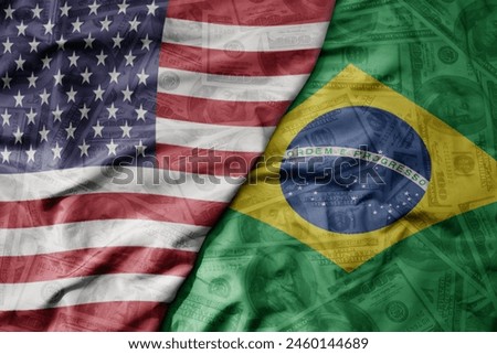 big waving colorful flag of united states of america and national flag of brazil on the dollar money background. finance concept. macro