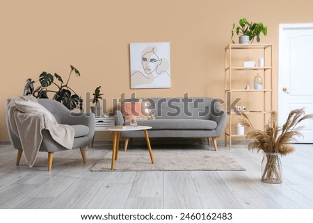 Stylish living room with comfortable sofa, coffee table and armchair