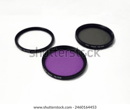 Three 52mm optical camera filters for photography cameras. A CPL "Circular Polarizer" filter, a UV "Ultraviolet" filter, and an FLD "Fluorescent Light Daylight" filer which have different functions.