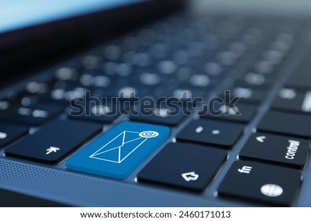 Light blue button with illustration of envelope and email sign on laptop keyboard, closeup