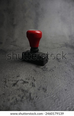 is a round stamp with red algae and black background, has good detail