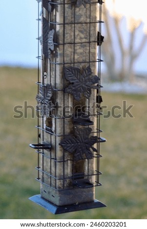 The isolated image of a full bird feeder.