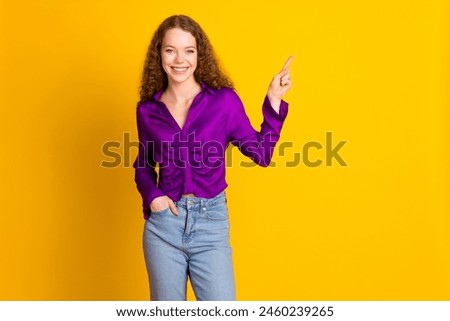 Photo portrait of lovely young lady point empty space dressed stylish violet garment isolated on yellow color background