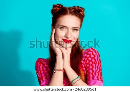 Photo of shiny adorable lady dressed pink knitted shirt arm cheek smiling empty space isolated blue color background