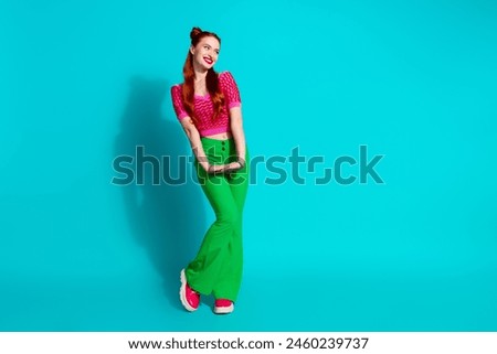 Full length photo of sweet dreamy lady dressed pink knitted shirt looking emtpy space isolated blue color background