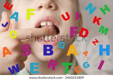small child 7 years old engaged with speech therapist, gymnastics for tongue front mirror, finger, colored letters, defect, speech disorder with frequent repetition sounds, syllables, spasms muscles Royalty-Free Stock Photo #2460241809