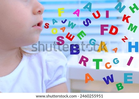 small child 3 years old engaged with speech therapist, gymnastics for tongue front mirror, colored letters, defect, speech disorder with frequent repetition sounds, syllables, spasms muscles apparatus Royalty-Free Stock Photo #2460255951