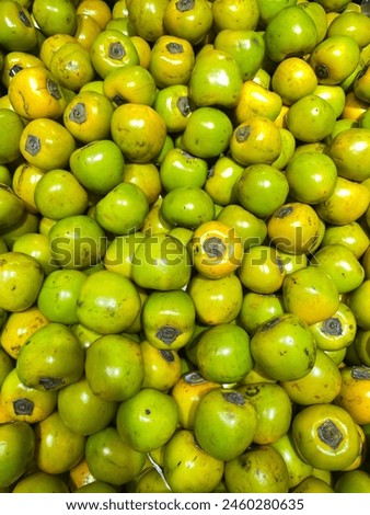 green persimmon in grocery store