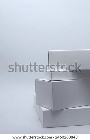 Different shapes of white cardboard boxes for presentation products on white background. Mockup for design.