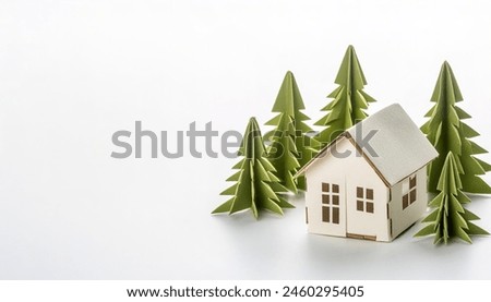 small home downsizing concept paper origami isolated on white background with green trees with copy space for rural living moving away from the city to a quiet environment with less population