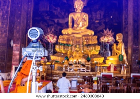 Selective focus to cameras and video transmission equipment for live Internet broadcasting at temples in Thailand.