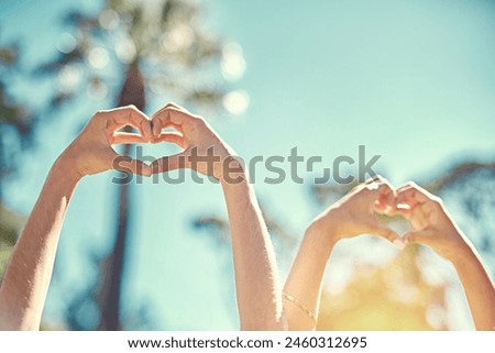 People, blue sky and hands with heart shape for teamwork, caring and support with kindness sign. Outdoor, friendship and love symbol for solidarity, wellness and peace with emoji gesture in nature