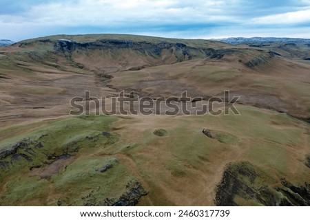 Volcanic canyon with hills covered green grass and moss. Drone photo. East Iceland. Tourist places