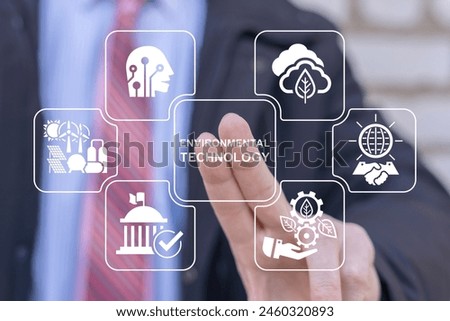 Business man using virtual touch screen presses inscription: ENVIRONMENTAL TECHNOLOGY. Environmental technology concept. Sustainable development goals. Sustainable planet trend. Green business.