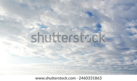 The sun shining through the puffy clouds. 3d ceiling decoration image. Sky bottom up view. Beautiful sunny sky. Stretch ceiling sky model. Royalty-Free Stock Photo #2460331863
