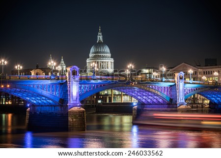 St Paul's Cathedral famous landmark of London poking behind Southwark bridge, London , England.