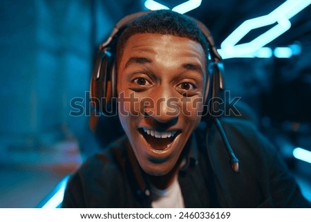 Portrait of a happy computer gamer in headphones. High quality photo