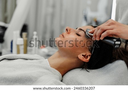Woman receiving facial massage in beauty salon. High quality photo