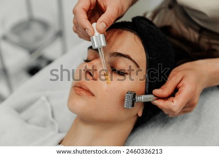 Woman receiving facial massage in beauty salon. High quality photo