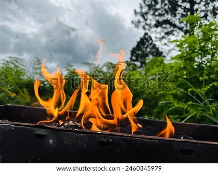 BBQ grill on fire at camping in wangedigala mountain peak sri lanka.